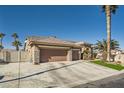 Front view of a house with a two-car garage and gated driveway at 7131 Celadine St, Las Vegas, NV 89131