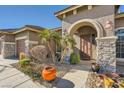 Inviting front entrance with stone accents and mature palm trees at 7131 Celadine St, Las Vegas, NV 89131