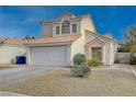 Two-story house with a white garage door and desert landscaping at 7214 Paradise Bay Dr, Las Vegas, NV 89119