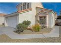 Two-story house with a white garage door and desert landscaping at 7214 Paradise Bay Dr, Las Vegas, NV 89119