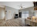 Bright living room featuring a comfy couch and wood-look floors at 7255 W Sunset Rd # 1115, Las Vegas, NV 89113