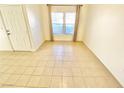 Bright living room with tile flooring and two windows at 8250 N Grand Canyon Dr # 1105, Las Vegas, NV 89166