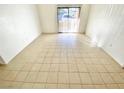 Spacious living room with tile floors and access to patio at 8250 N Grand Canyon Dr # 1105, Las Vegas, NV 89166