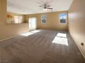 Spacious living room with large windows and light-colored carpeting at 8465 Bellery Ave, Las Vegas, NV 89143