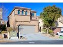 Two-story house with attached garage and landscaping at 9328 Black Wolf Ave, Las Vegas, NV 89178