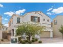 Inviting two-story home with a tile roof, two-car garage, and mature landscaping in front at 9625 Ponderosa Skye Ct, Las Vegas, NV 89166