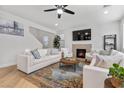 Bright living room with fireplace, stylish decor, and neutral color palette with beautiful hardwood floors at 9625 Ponderosa Skye Ct, Las Vegas, NV 89166