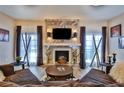 Living room with fireplace, hardwood floors, and large windows at 1409 E St Louis Ave # A, Las Vegas, NV 89104
