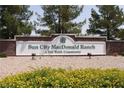Welcoming entrance to Sun City MacDonald Ranch, a Del Webb community, with beautiful landscaping at 2101 Desert Woods Dr, Henderson, NV 89012