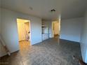 Open living room features tile flooring and custom built-in shelving, offering storage and style at 2206 Farmouth Cir, North Las Vegas, NV 89032