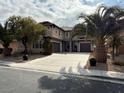 Two-story home with three-car garage and landscaping at 2621 Slide Canyon Ave, North Las Vegas, NV 89081