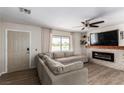 Living room featuring a fireplace, sectional sofa, and large TV at 2931 Rodeo Ave, Pahrump, NV 89048