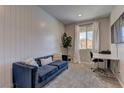 Home office with a navy couch and a workspace at 319 Cooper Hawk Ct, Las Vegas, NV 89138