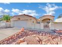 Single-story home with a two-car garage and desert landscaping at 476 Tiger Lily Way, Henderson, NV 89015