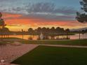 Breathtaking sunset view from the backyard overlooking the pond and golf course, complete with lush green grass at 5130 Agio Ave, Pahrump, NV 89061