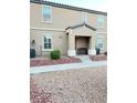 Tan two-story house with a small front porch at 5197 Silica Chalk Ave, Las Vegas, NV 89115