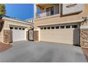 Two-car garage with attached pedestrian gate at 7032 N Albatross Attic St, North Las Vegas, NV 89084