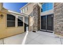 Backyard patio with access to the house and large windows at 7032 N Albatross Attic St, North Las Vegas, NV 89084