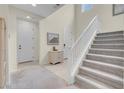 Bright entryway with staircase, mirror, and neutral color palette at 7061 Stockton Dunes St, North Las Vegas, NV 89084