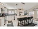 Bright kitchen featuring a large island, stainless steel appliances, and white cabinetry at 7277 Abbeyville Dr, Las Vegas, NV 89119