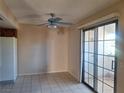 Bright dining area with tile flooring and sliding glass door access to a patio at 6653 W Tropicana Ave # 101, Las Vegas, NV 89103