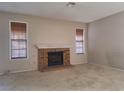 Living room with brick fireplace and neutral carpeting at 6653 W Tropicana Ave # 101, Las Vegas, NV 89103
