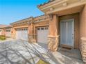 Front entrance with double door garage and stone accents at 10840 Villa Torre St, Las Vegas, NV 89141