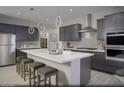 Modern kitchen with gray cabinets, white countertops, and an island at 10965 Cilantro Ave # Lot 108, Las Vegas, NV 89166