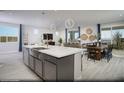 Large kitchen island with white countertop and stainless steel sink at 10965 Cilantro Ave # Lot 108, Las Vegas, NV 89166