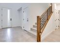 Bright entryway with tile floors, modern door, and staircase at 11935 Glide Reflection Ave, Las Vegas, NV 89138