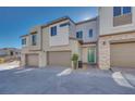 Contemporary townhome showcasing an inviting front entrance and attached garage at 11935 Glide Reflection Ave, Las Vegas, NV 89138