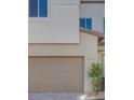 Attached garage with taupe-colored door and stone facade at 11935 Glide Reflection Ave, Las Vegas, NV 89138