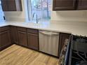 Kitchen with stainless steel dishwasher and light wood flooring at 1732 Monte Alban Dr, North Las Vegas, NV 89031