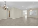 Spacious dining room with tile floors and elegant chandelier at 2067 Bliss Corner St, Henderson, NV 89044