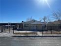 House with a black metal fence and a paved driveway at 2410 Poplar Ave, Las Vegas, NV 89101