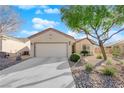 Single-story house with a two-car garage and nicely landscaped yard at 2525 Shore Bird Ave, North Las Vegas, NV 89084