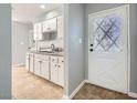 Kitchen with white cabinets, granite counters, and tile floor at 2620 Shiloh Way, North Las Vegas, NV 89030