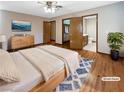 Virtually staged main bedroom with hardwood floors and en-suite bathroom at 311 E Desert Rose Dr, Henderson, NV 89015