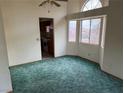 Bright dining room with teal carpet and access to the kitchen at 3160 James A Bilbray Pkwy, Laughlin, NV 89029