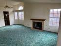 Living room with a fireplace and teal carpet at 3160 James A Bilbray Pkwy, Laughlin, NV 89029