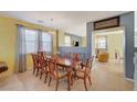 Formal dining room with a large wood table and eight chairs at 3517 Colby Creek Ave, North Las Vegas, NV 89081