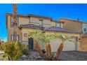 Tan two-story house with palm trees and a paved driveway at 3517 Colby Creek Ave, North Las Vegas, NV 89081