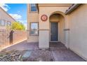 Inviting front entrance with covered porch, decorative sun accent, and brick pathway at 3517 Colby Creek Ave, North Las Vegas, NV 89081