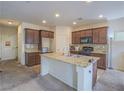 Island kitchen with granite countertops and dark wood cabinets at 372 Monique Springs St, Henderson, NV 89014