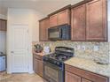 Kitchen features granite countertops, dark wood cabinets, and built-in appliances at 372 Monique Springs St, Henderson, NV 89014