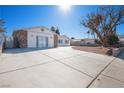 House exterior with large driveway and mature tree at 3939 Springhill Ave, Las Vegas, NV 89121