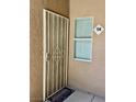 Front door with security gate and welcome mat at 5751 E Hacienda Ave # 114, Las Vegas, NV 89122