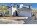 Inviting two-story home featuring a brick driveway and a modern two-car garage at 6 Lilla Rosa St, Henderson, NV 89011