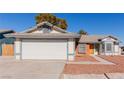 House exterior showcasing a two-car garage and neatly kept landscaping at 6200 Budnick Cir, Las Vegas, NV 89130