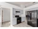 Modern kitchen with gray cabinets and black appliances at 6200 Budnick Cir, Las Vegas, NV 89130